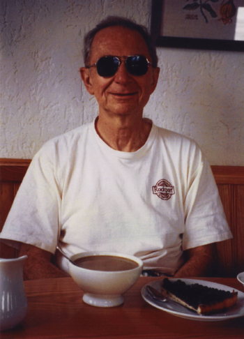 Leon with a huge cup of coffee and pie, after a long day of hiking with Eve in the Swiss Alps.